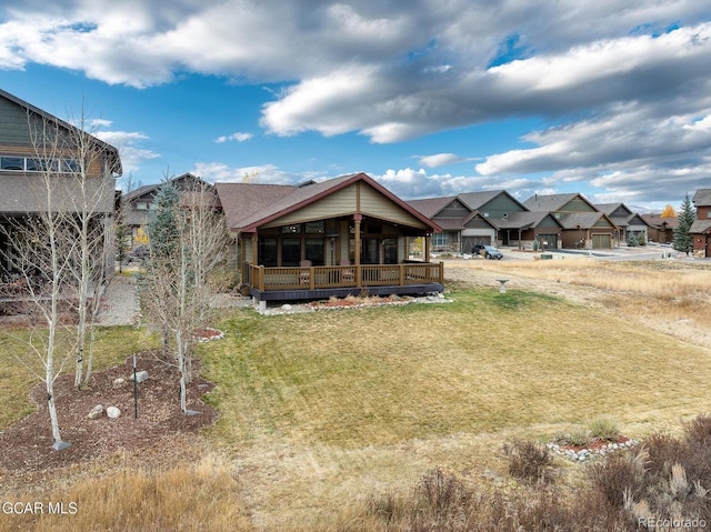 back of property featuring a lawn