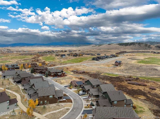 birds eye view of property with a mountain view