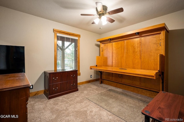 interior space featuring ceiling fan and light colored carpet