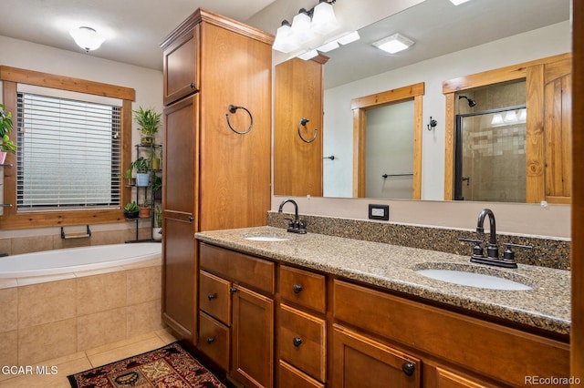 bathroom with tile patterned flooring, vanity, and plus walk in shower