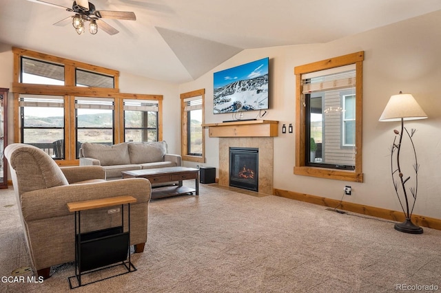 living room featuring carpet flooring, vaulted ceiling, a fireplace, and ceiling fan