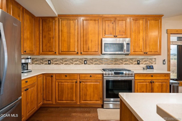 kitchen featuring backsplash, dark hardwood / wood-style flooring, and stainless steel appliances