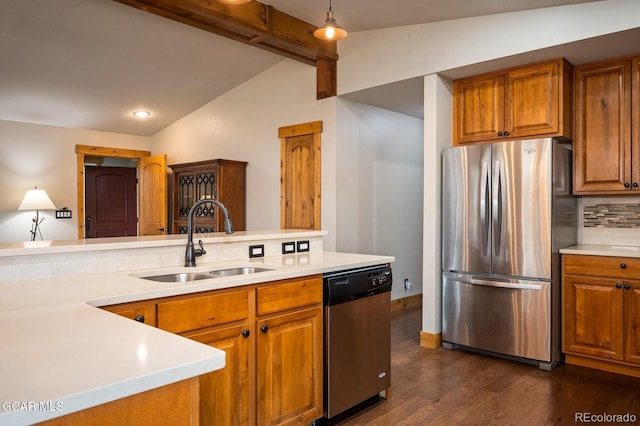 kitchen with appliances with stainless steel finishes, tasteful backsplash, sink, decorative light fixtures, and vaulted ceiling with beams