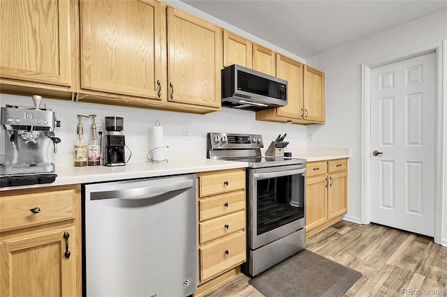 4251 S Blackhawk Cir Unit 3E, Aurora, CO 80014 - kitchen with appliances with stainless steel finishes, light brown cabinets, light wood-type flooring, and light countertops