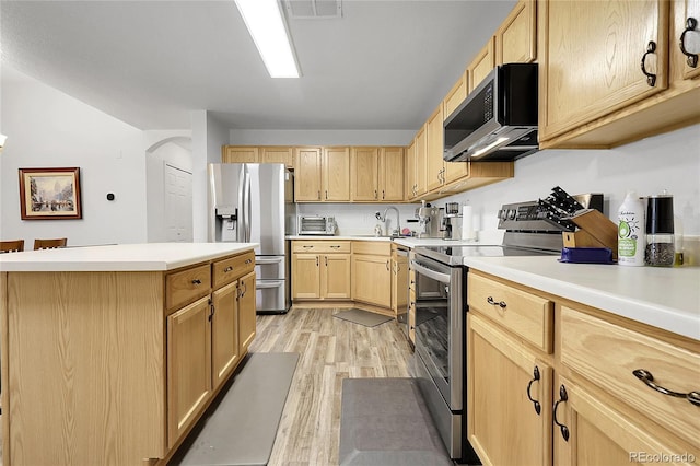 4251 S Blackhawk Cir Unit 3E, Aurora, CO 80014 - kitchen with stainless steel appliances, light wood-type flooring, light brown cabinets, and light countertops