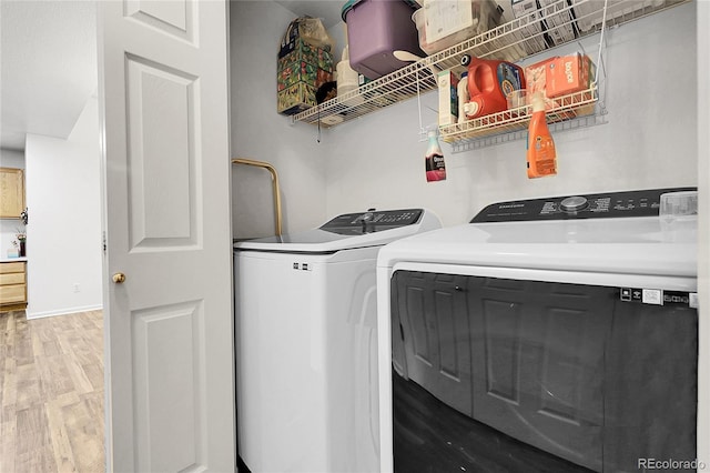 4251 S Blackhawk Cir Unit 3E, Aurora, CO 80014 - washroom with washing machine and dryer and light wood finished floors