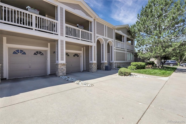4251 S Blackhawk Cir Unit 3E, Aurora, CO 80014 - view of front of home with a garage, driveway, and stone siding