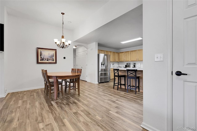 4251 S Blackhawk Cir Unit 3E, Aurora, CO 80014 - dining room featuring a chandelier and light wood-style floors