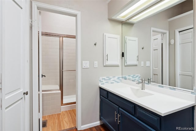 7035 S Flower Ct, Littleton, CO 80128 - bathroom with a shower stall, vanity, wood finished floors, and baseboards