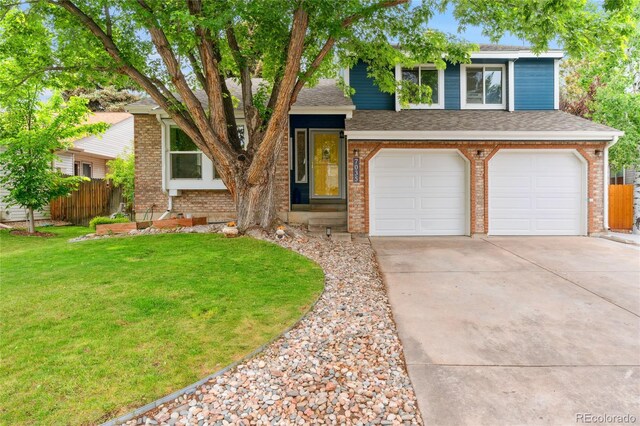 7035 S Flower Ct, Littleton, CO 80128 - split level home with an attached garage, driveway, brick siding, and a shingled roof