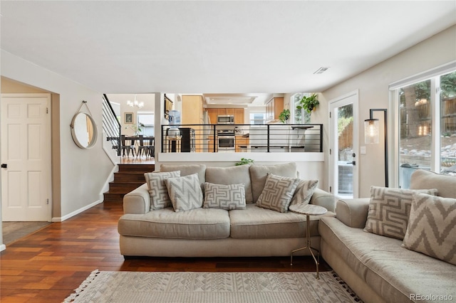 7035 S Flower Ct, Littleton, CO 80128 - living area featuring a chandelier, wood finished floors, stairs, and baseboards