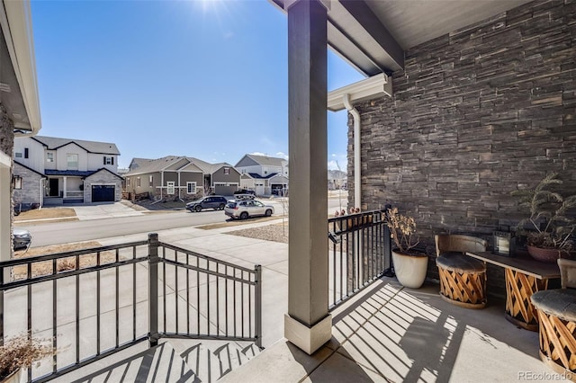 balcony featuring a porch and a residential view