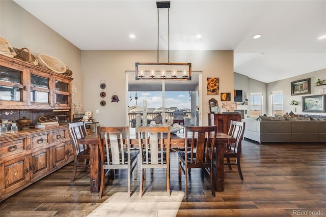 dining area featuring lofted ceiling, dark wood-style flooring, and recessed lighting