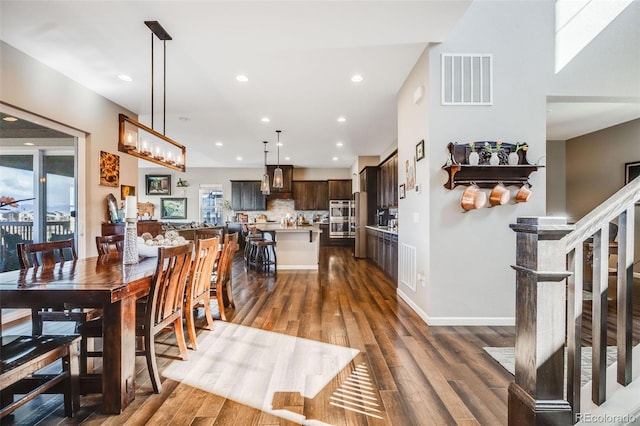 dining area featuring stairway, visible vents, wood finished floors, and recessed lighting