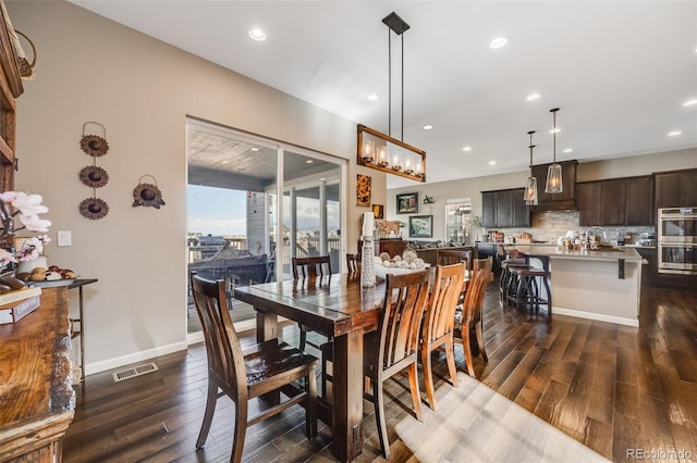 dining area with baseboards, visible vents, dark wood finished floors, and recessed lighting