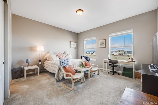 carpeted bedroom with baseboards