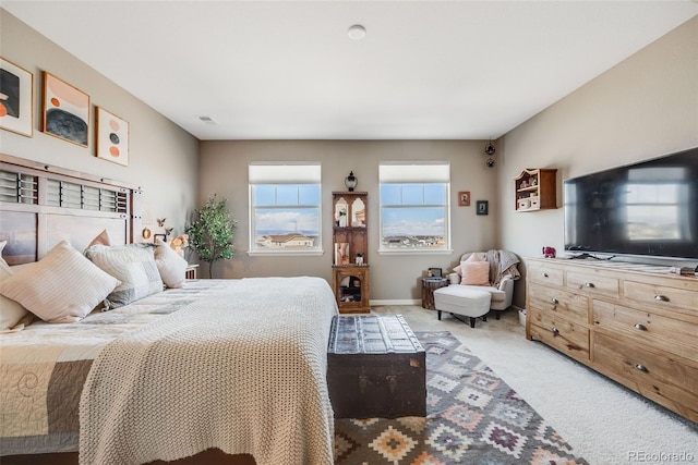 carpeted bedroom featuring visible vents and baseboards