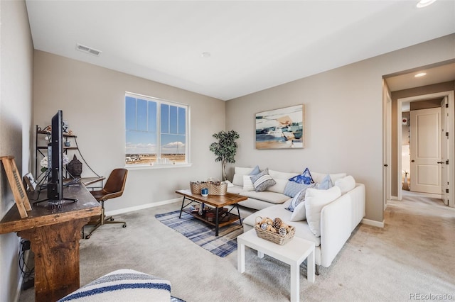 living area with carpet floors, baseboards, and visible vents