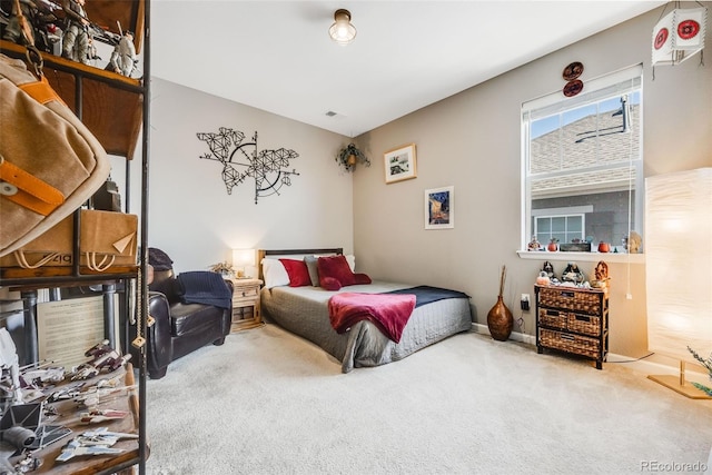 carpeted bedroom featuring visible vents and baseboards