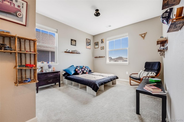 carpeted bedroom featuring visible vents and baseboards