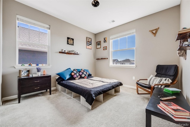 carpeted bedroom with visible vents and baseboards