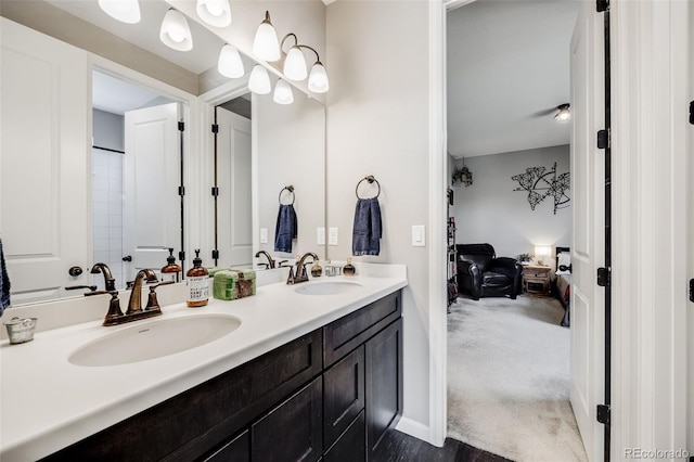 bathroom featuring double vanity, a sink, and connected bathroom