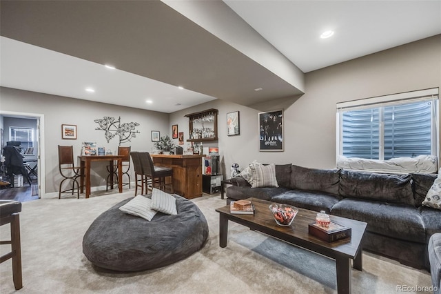 living area featuring a dry bar, light carpet, baseboards, and recessed lighting