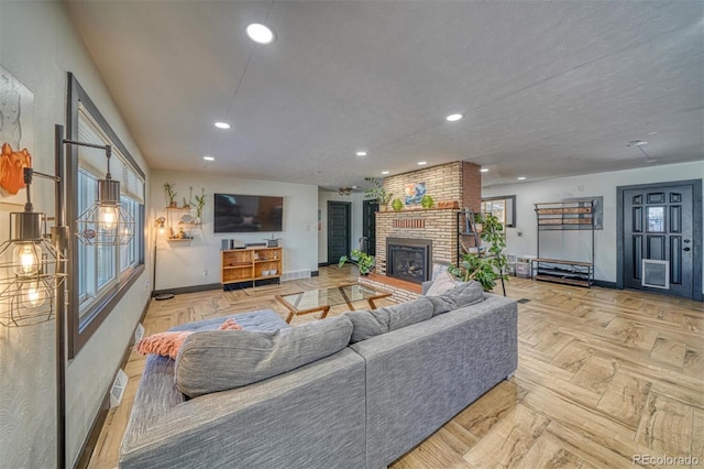 living room with a fireplace and light parquet floors