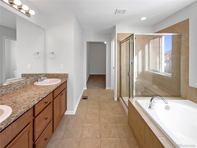 bathroom with tile patterned floors, independent shower and bath, and vanity