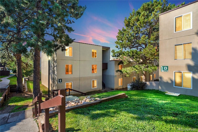 9700 E Iliff Ave Unit E51, Denver, CO 80231 - back of property at dusk with a lawn and stucco siding