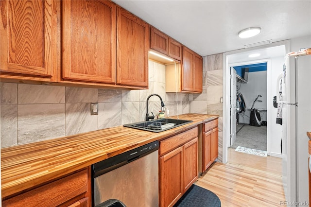 9700 E Iliff Ave Unit E51, Denver, CO 80231 - kitchen with stainless steel dishwasher, freestanding refrigerator, butcher block counters, light wood-style floors, and brown cabinetry