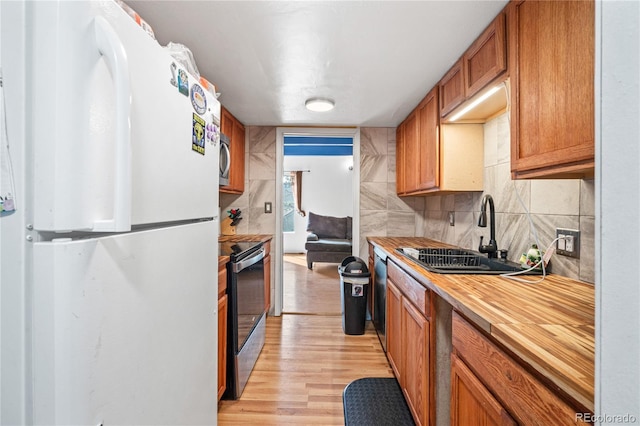 9700 E Iliff Ave Unit E51, Denver, CO 80231 - kitchen featuring appliances with stainless steel finishes, butcher block counters, light wood-style flooring, brown cabinets, and tasteful backsplash