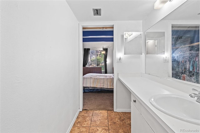 9700 E Iliff Ave Unit E51, Denver, CO 80231 - ensuite bathroom featuring vanity and tile patterned flooring