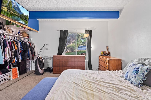 9700 E Iliff Ave Unit E51, Denver, CO 80231 - bedroom featuring carpet flooring, a textured ceiling, and a closet