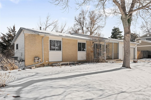 view of snow covered rear of property