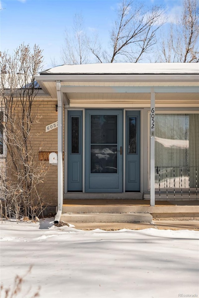 view of snow covered property entrance