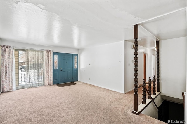 view of carpeted foyer entrance