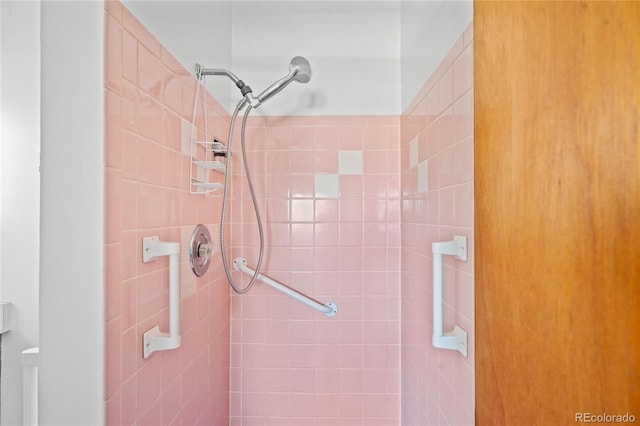 bathroom with tiled shower