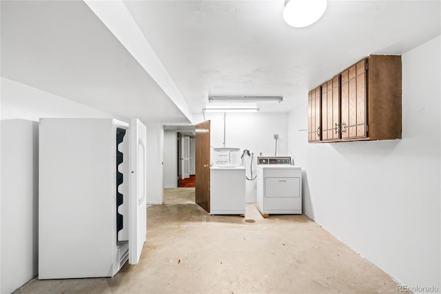 laundry room featuring cabinets and washer and clothes dryer