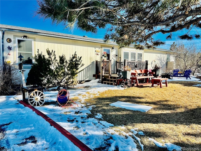 snow covered property featuring a lawn