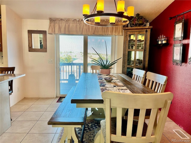 dining area featuring light tile patterned floors and a notable chandelier