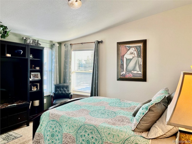 bedroom with lofted ceiling and a textured ceiling