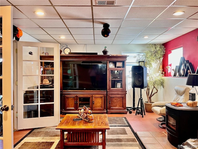 living room featuring a drop ceiling and a wealth of natural light