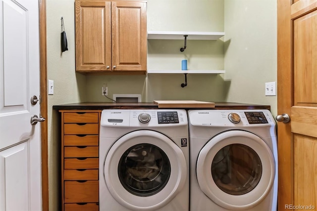 clothes washing area with cabinet space and independent washer and dryer