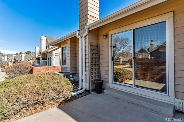 property entrance with a chimney