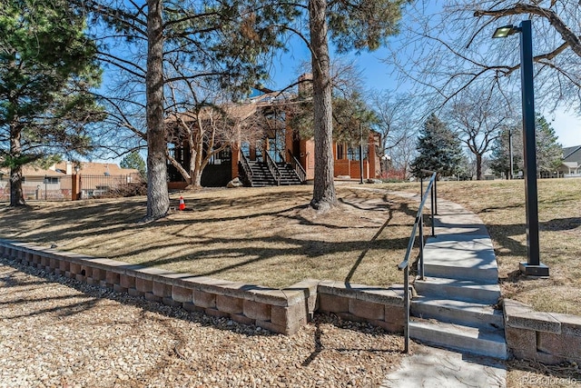 view of yard with stairs and fence