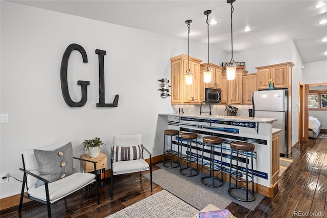 504 Ravenwood Dr Unit B2, Grand Lake, CO 80447 - kitchen featuring freestanding refrigerator, dark wood finished floors, decorative backsplash, a peninsula, and light countertops