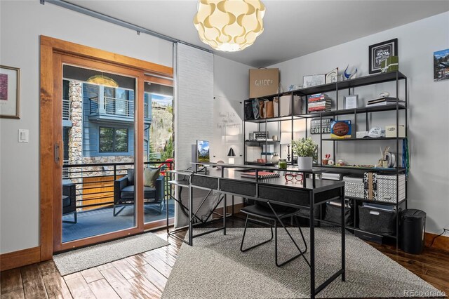 504 Ravenwood Dr Unit B2, Grand Lake, CO 80447 - office with wood finished floors, a chandelier, and baseboards