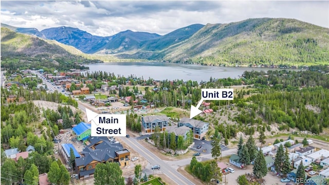 504 Ravenwood Dr Unit B2, Grand Lake, CO 80447 - drone / aerial view of a water and mountain view and a heavily wooded area