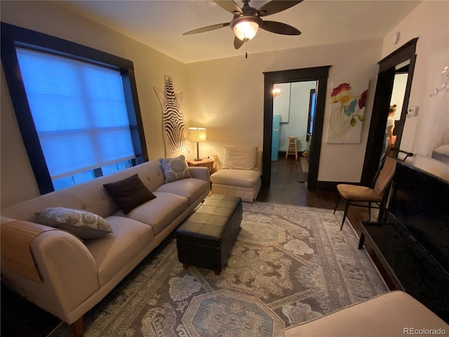 living room with wood finished floors and ceiling fan